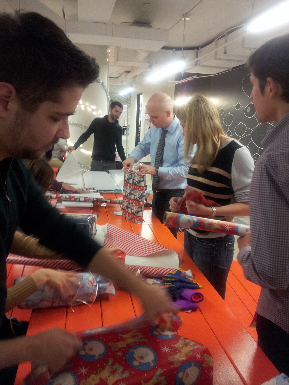 At our holiday party everyone pitched in a hand to help wrap.