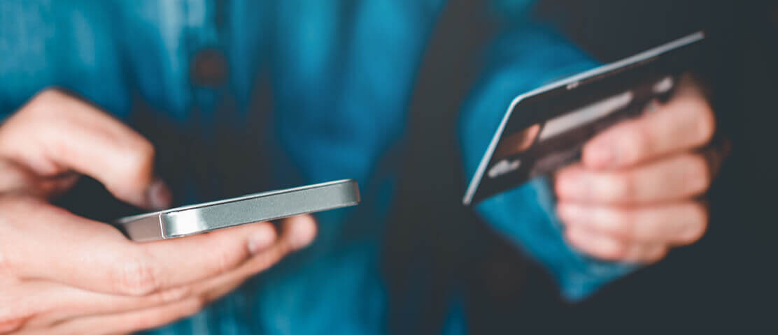 Man holding mobile phone and credit card